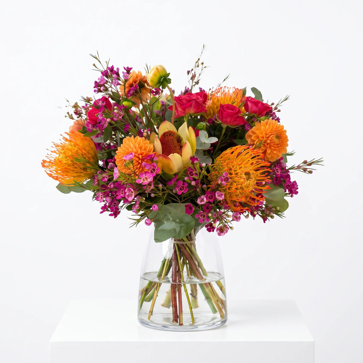 Fuchsia Flame flower bouquet arranged in a glass vase