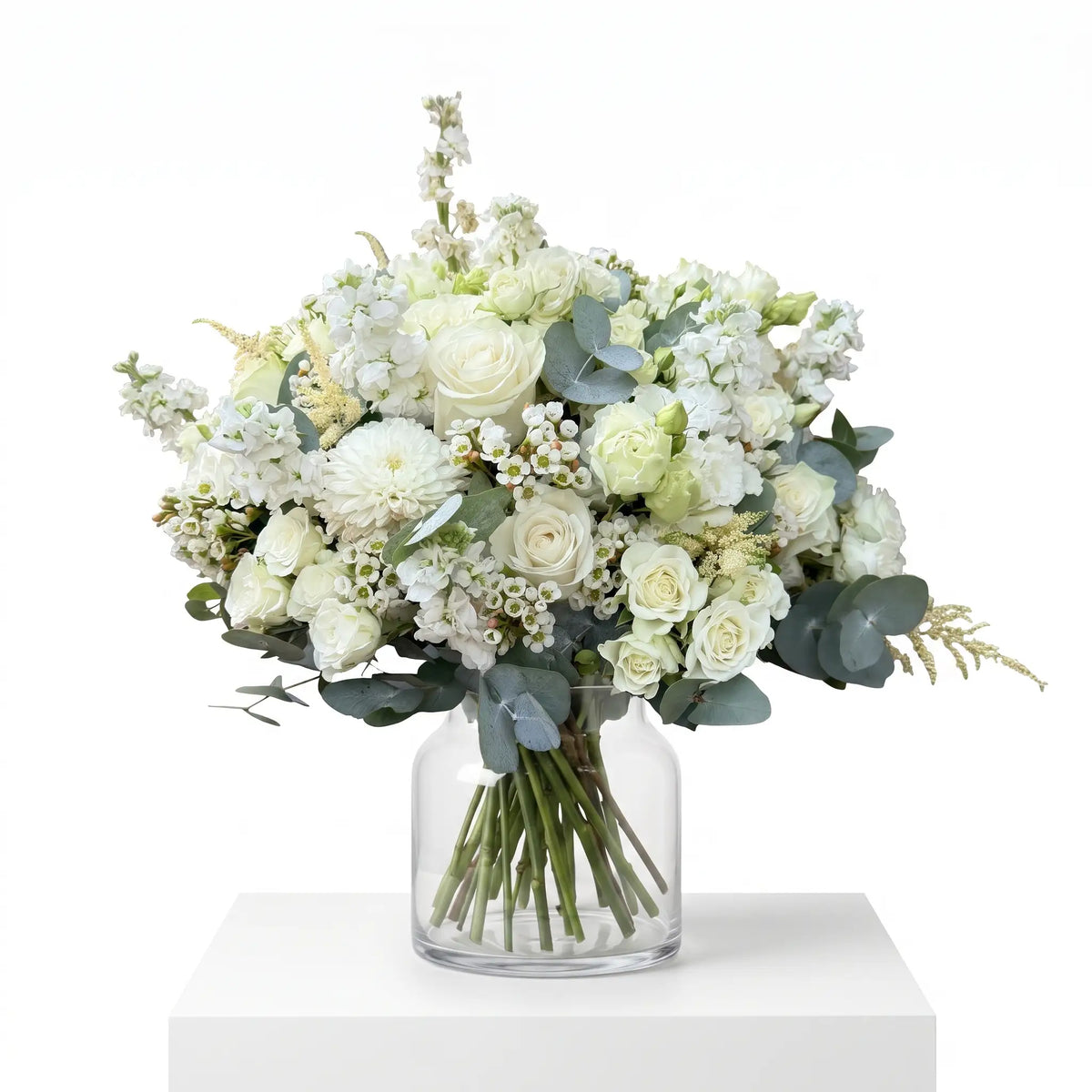 Ivory Mist flower bouquet arranged in a glass vase