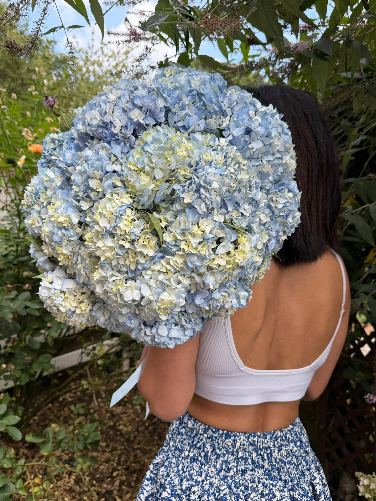 Just Hydrangeas Blue hydrangea bouquet styled in a lifestyle setting
