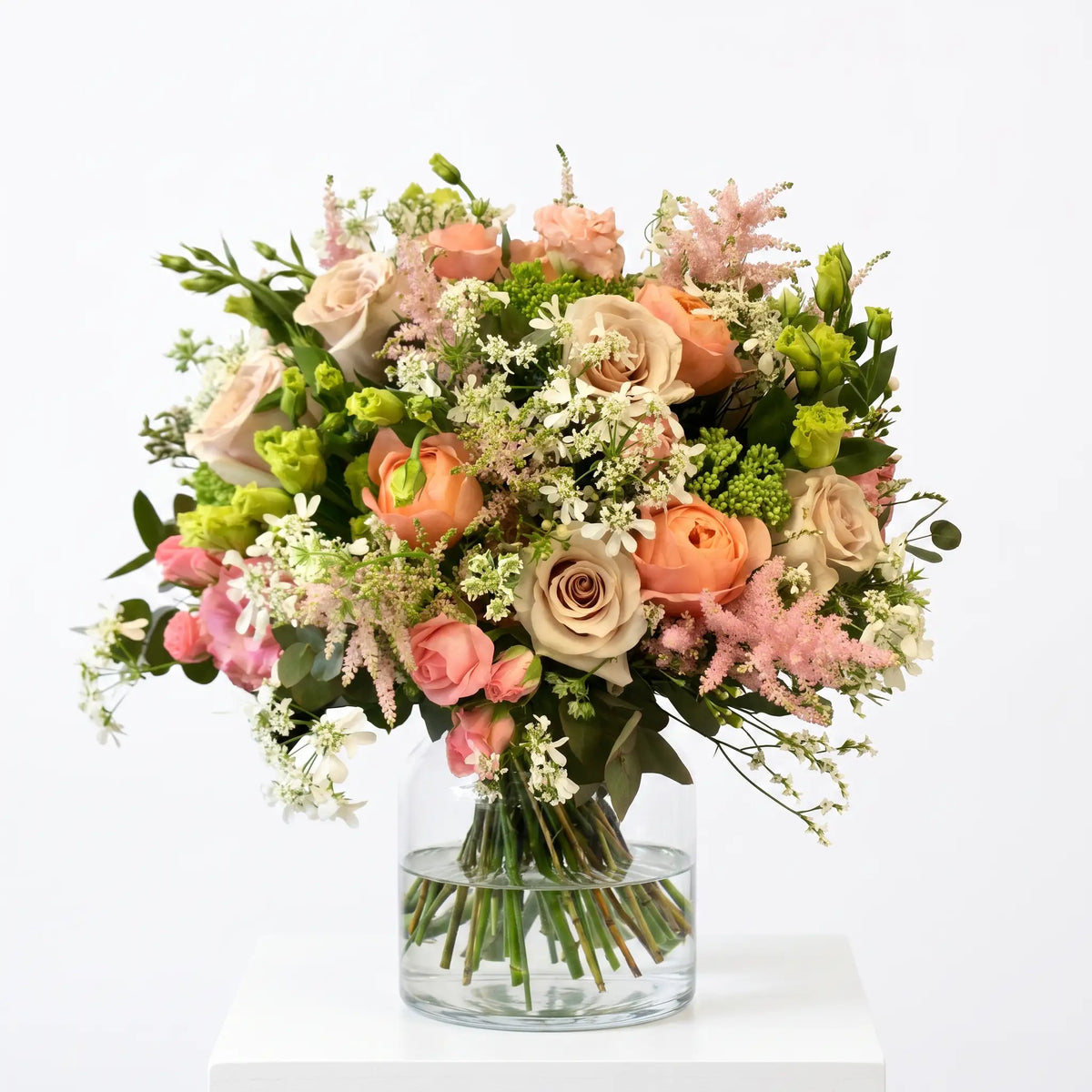 Peach Reverie flower bouquet arranged in a glass vase