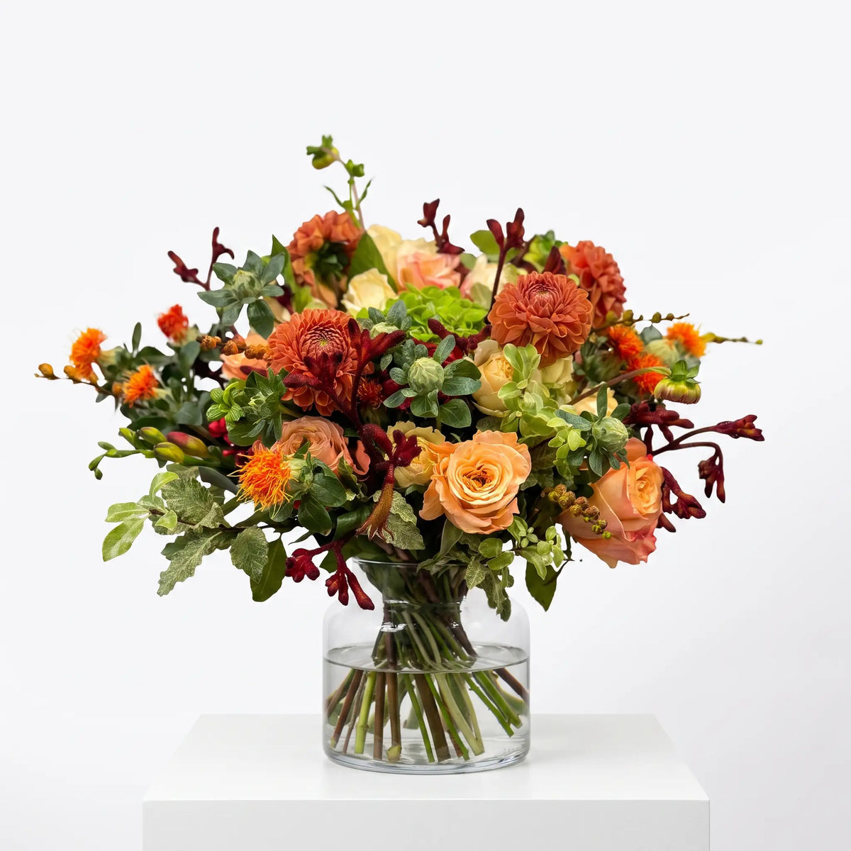 Sunset Grove flower bouquet arranged in a glass vase